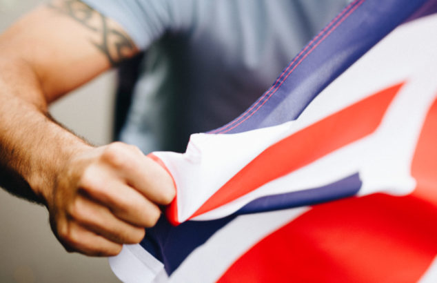 Man showing his fist with UK flag during a protest